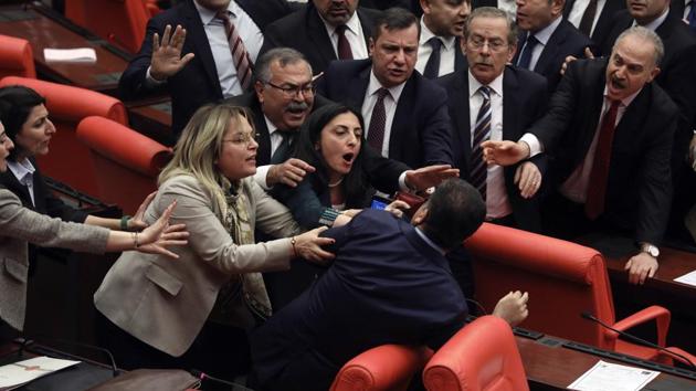 Legislators push each other as a brawl breaks out between lawmakers from opposing parties during a tense discussion about Turkey's military involvement in northwest Syria, in Turkey's parliament in Ankara, Turkey. (AP) Legislators push each other as a brawl breaks out between lawmakers from opposing parties during a tense discussion about Turkey's military involvement in northwest Syria, in Turkey's parliament in Ankara, Turkey. (AP)
