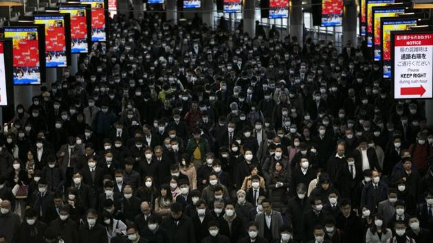 A large crowd of mask-wearing commuters walk through Shinagawa Station in Tokyo, Japan. The government has indicated it sees the next couple of weeks as crucial to containing the spread of COVID-19, which was discovered in China in late 2019. (Jae C. Hong / AP) A large crowd of mask-wearing commuters walk through Shinagawa Station in Tokyo, Japan. The government has indicated it sees the next couple of weeks as crucial to containing the spread of COVID-19, which was discovered in China in late 2019. (Jae C. Hong / AP)
