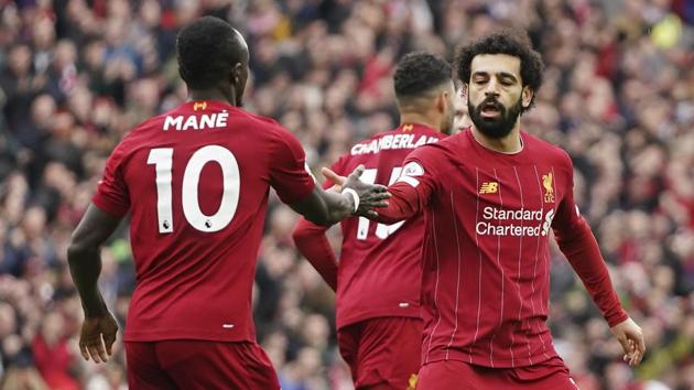 Liverpool's Mohamed Salah, right, celebrates with his teammate Sadio Mane after scoring his side's opening goal.(AP)