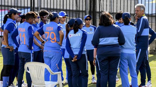 India's coach Woorkeri Raman (R) speaks to the players in the nets ahead of the Twenty20 women's World Cup cricket final.(AFP)