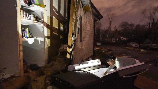 Nicole looks through her refrigerator after it was ripped out of her home at Underwood St. and 16th Ave. N. after a tornado ripped a wall off in the Elizabeth Park neighbourhood of Nashville, Tennessee, USA. (George Walker IV / The Tennessean via AP) Nicole looks through her refrigerator after it was ripped out of her home at Underwood St. and 16th Ave. N. after a tornado ripped a wall off in the Elizabeth Park neighbourhood of Nashville, Tennessee, USA. (George Walker IV / The Tennessean via AP)