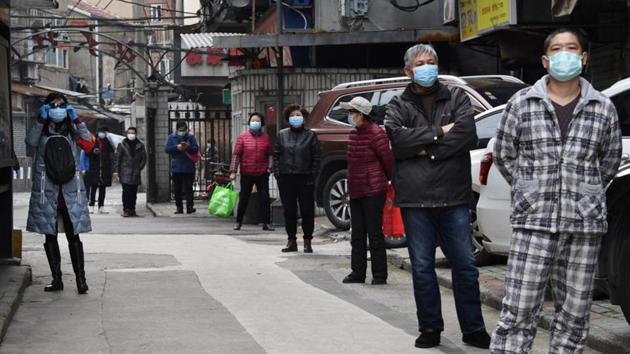 Residents line up to collect vegetables purchased through group orders at a residential area in Wuhan, the epicentre of the novel coronavirus outbreak, Hubei province, China.(REUTERS) Residents line up to collect vegetables purchased through group orders at a residential area in Wuhan, the epicentre of the novel coronavirus outbreak, Hubei province, China.(REUTERS)