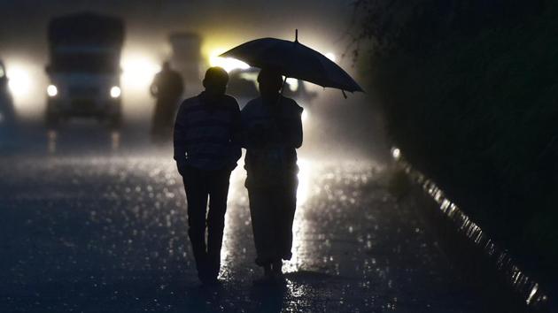 Commuters are silhouetted while holding an umbrella during sudden rain. Noida and the neighbouring cities breathed their cleanest air of the year on Friday, all thanks to the strong winds and rains in the past three days that improved the air quality to ‘good’. (Virendra Singh Gosain / HT Photo) Commuters are silhouetted while holding an umbrella during sudden rain. Noida and the neighbouring cities breathed their cleanest air of the year on Friday, all thanks to the strong winds and rains in the past three days that improved the air quality to ‘good’. (Virendra Singh Gosain / HT Photo)