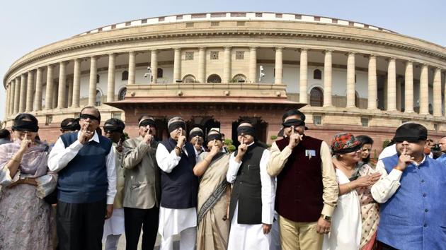 Trinamool Congress (TMC) members with black cloths tied over their eyes put fingers on their lips as part of their protest over the recent violence in north-east Delhi, during the second phase of budget session in Parliament, in New Delhi. (Sanjeev Verma / HT Photo) Trinamool Congress (TMC) members with black cloths tied over their eyes put fingers on their lips as part of their protest over the recent violence in north-east Delhi, during the second phase of budget session in Parliament, in New Delhi. (Sanjeev Verma / HT Photo)