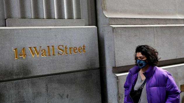 A person wearing a face mask walks along Wall Street after further cases of coronavirus were confirmed in New York City, New York. (REUTERS) A person wearing a face mask walks along Wall Street after further cases of coronavirus were confirmed in New York City, New York. (REUTERS)