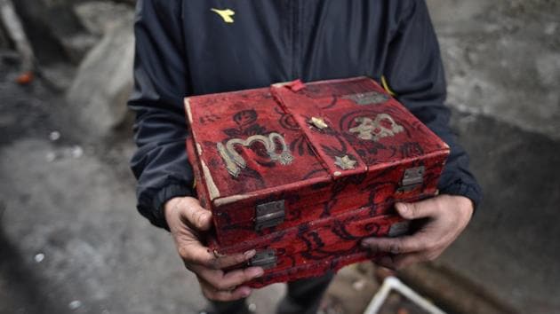 A person carries a chest containing Quran, that was recovered from his house burnt during the recent communal violence in north-east Delhi, at Shiv Vihar, in New Delhi. (Sanchit Khanna / HT Photo) A person carries a chest containing Quran, that was recovered from his house burnt during the recent communal violence in north-east Delhi, at Shiv Vihar, in New Delhi. (Sanchit Khanna / HT Photo)
