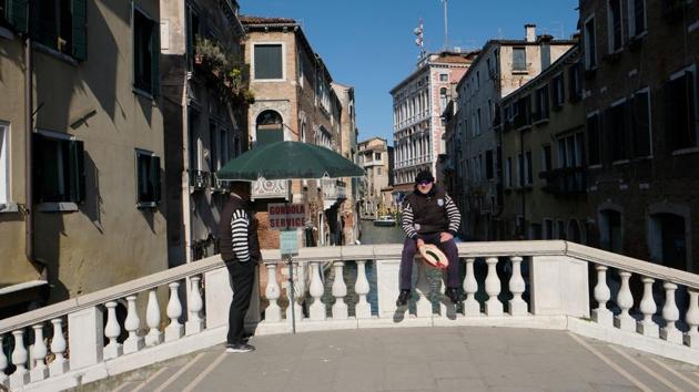 Gondoliers wait for tourists as the Italian government prepares to adopt new measures to contain the spread of coronavirus in Venice, Italy. (REUTERS) Gondoliers wait for tourists as the Italian government prepares to adopt new measures to contain the spread of coronavirus in Venice, Italy. (REUTERS)