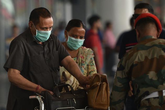 Passengers are seen wearing safety masks for prevention against coronavirus, at Netaji Subhas Chandra Bose International (NSCBI) airport, in Kolkata, India.(HT Photo/Samir Jana)