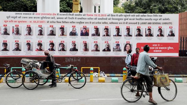 Lucknow administration put up hoardings with photographs, names, and addresses of 57 people who have been issued recovery notice for their alleged involvement in violence during anti CAA protest last December.(ANI)