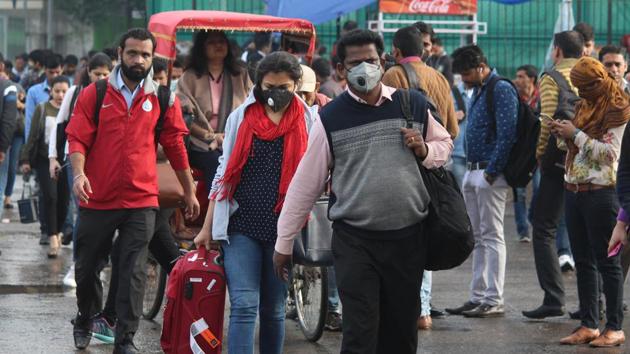 People in Gurugram wearing protective masks following multiple positive cases of coronavirus in the country.(Yogendra Kumar/HT PHOTO)