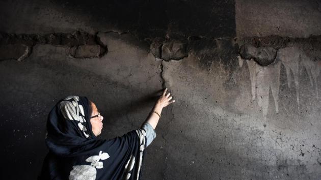 Razia, a victim, examines her burnt house after last week's violence in north-east Delhi over the Citizenship Amendment Act (CAA), at Brijpuri in New Delhi. (Raj K Raj / HT Photo) Razia, a victim, examines her burnt house after last week's violence in north-east Delhi over the Citizenship Amendment Act (CAA), at Brijpuri in New Delhi. (Raj K Raj / HT Photo)