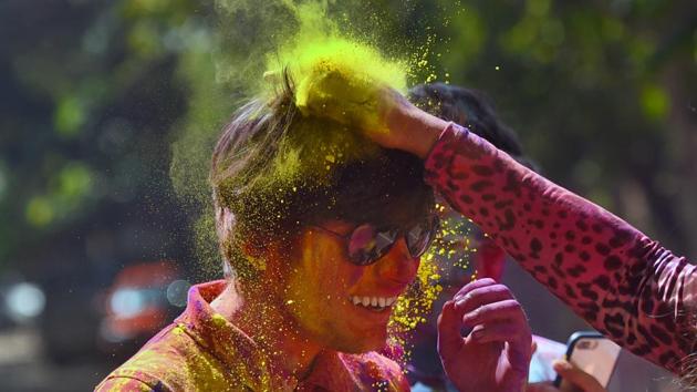 Students smear colours on each other on the eve of the Hindu festival of Holi, at KG Marg in New Delhi, India. (Amal KS/HT PHOTO) Students smear colours on each other on the eve of the Hindu festival of Holi, at KG Marg in New Delhi, India. (Amal KS/HT PHOTO)