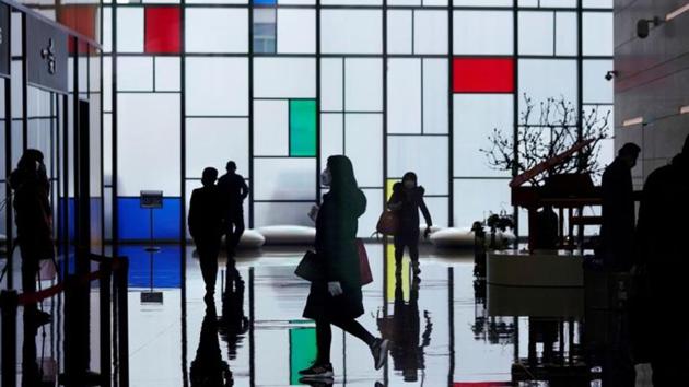 People wearing face masks walk inside an office building at the Lujiazui financial district in Pudong, Shanghai, China. (Reuters file photo) People wearing face masks walk inside an office building at the Lujiazui financial district in Pudong, Shanghai, China. (Reuters file photo)