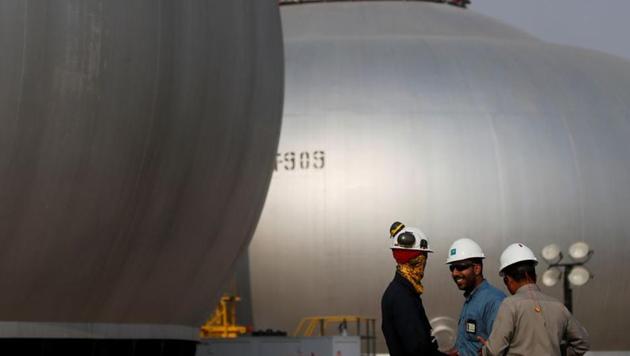 Employees are seen next to spheroids under reconstruction at Saudi Aramco oil facility in Abqaiq, Saudi Arabia.(Reuters file photo)