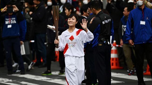 (FILES) In this file photo taken on February 15, 2020, a runner waves while holding an Olympic torch during a rehearsal for the Tokyo 2020 Olympics torch relay in Tokyo. - Warnings of radiation hotspots in parts of Fukushima that will host the Olympic torch relay and several sporting events have made headlines, but what is the risk for athletes and spectators? (Photo by CHARLY TRIBALLEAU / AFP) / TO GO WITH Nuclear-Fukushima-JPN-Oly-2020-Japan-hotspots,FOCUS by Sara HUSSEIN (AFP) (FILES) In this file photo taken on February 15, 2020, a runner waves while holding an Olympic torch during a rehearsal for the Tokyo 2020 Olympics torch relay in Tokyo. - Warnings of radiation hotspots in parts of Fukushima that will host the Olympic torch relay and several sporting events have made headlines, but what is the risk for athletes and spectators? (Photo by CHARLY TRIBALLEAU / AFP) / TO GO WITH Nuclear-Fukushima-JPN-Oly-2020-Japan-hotspots,FOCUS by Sara HUSSEIN (AFP)