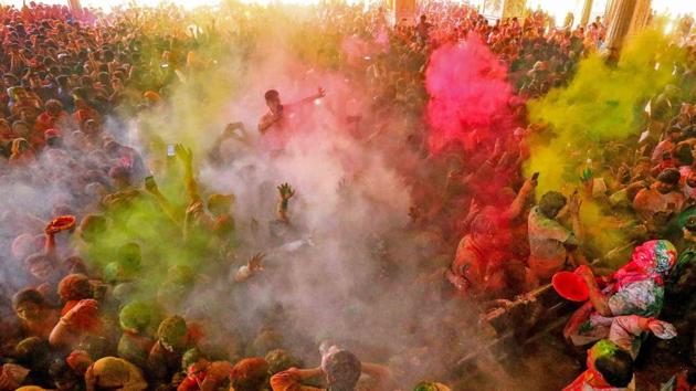 A riot of colours fills the air, creating a scene quintessential to the festival as revelers celebrate at the Govind Dev Ji Temple in Jaipur, Rajasthan. (PTI) A riot of colours fills the air, creating a scene quintessential to the festival as revelers celebrate at the Govind Dev Ji Temple in Jaipur, Rajasthan. (PTI)