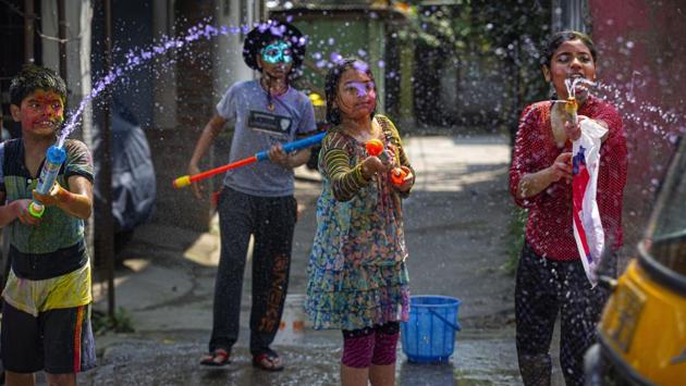 Children stocked with water spray guns and ‘pichkaris’ take aim at a passing auto-rickshaw a day before Holi in Guwahati, Assam. (Anupam Nath / AP) Children stocked with water spray guns and ‘pichkaris’ take aim at a passing auto-rickshaw a day before Holi in Guwahati, Assam. (Anupam Nath / AP)