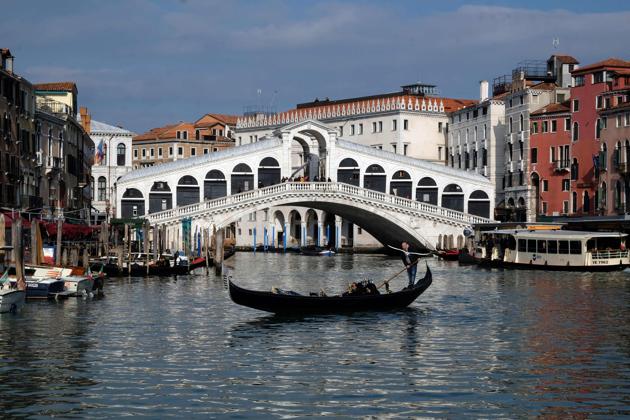 A gondola sails on an empty Grand Canal in Venice, Italy. A quarter of the Italian population was locked down on March 8 as the government took drastic steps to stop the spread of the deadly coronavirus that is sweeping the globe. Owing to the outbreak, the city is deserted even during the festive season. (Andrea Pattaro / AFP)