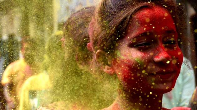 Revellers seen through a cloud of yellow, as people step out to celebrate the arrival of Holi in Kolkata, West Bengal. (Samir Jana / HT Photo) Revellers seen through a cloud of yellow, as people step out to celebrate the arrival of Holi in Kolkata, West Bengal. (Samir Jana / HT Photo)