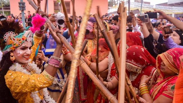 Devotees celebrate Lathmar Holi at Gokul near Mathura, Uttar Pradesh. The small town of Barsana, situated approximately 42 kms from Mathura is famous for its unique way of celebrating the festival. The women of Barsana chase the men from the village and hit them playfully with sticks. (PTI) Devotees celebrate Lathmar Holi at Gokul near Mathura, Uttar Pradesh. The small town of Barsana, situated approximately 42 kms from Mathura is famous for its unique way of celebrating the festival. The women of Barsana chase the men from the village and hit them playfully with sticks. (PTI)
