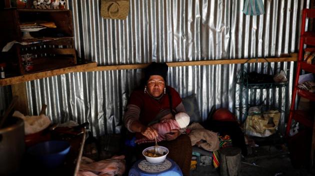 Eva Chura breastfeeds her three-month-old son Alizon, as she eats inside their room in La Rinconada. "In a week sometimes I can get 1 gram or 2 grams of gold," Chura said. "If I'm lucky it can sometimes be 20 grams, but that's down to luck." She further added, "Sometimes there's gold, other times no. At the moment it's very low.” (Nacho Doce / REUTERS) Eva Chura breastfeeds her three-month-old son Alizon, as she eats inside their room in La Rinconada. "In a week sometimes I can get 1 gram or 2 grams of gold," Chura said. "If I'm lucky it can sometimes be 20 grams, but that's down to luck." She further added, "Sometimes there's gold, other times no. At the moment it's very low.” (Nacho Doce / REUTERS)