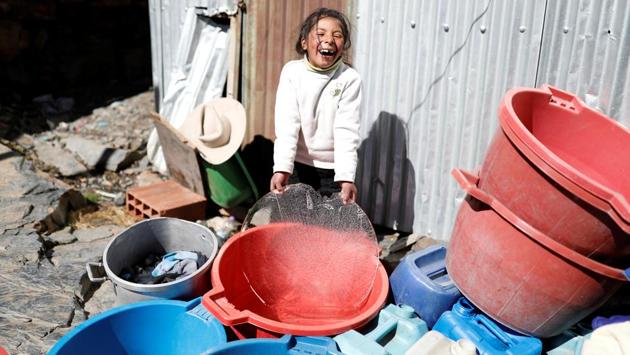 Yaquelin, 10, the daughter of Eva Chura, smiles as she picks up a piece of ice by the entrance of their home in La Rinconada. The fragments of gold these people produce have, at least in the past, made their way into supply chains of firms including phone makers and jewellers. In 2018 a Swiss refinery that had been taking the metal for years stopped after Peruvian prosecutors alleged the company that collected it was a front for organised crime. (Nacho Doce / REUTERS) Yaquelin, 10, the daughter of Eva Chura, smiles as she picks up a piece of ice by the entrance of their home in La Rinconada. The fragments of gold these people produce have, at least in the past, made their way into supply chains of firms including phone makers and jewellers. In 2018 a Swiss refinery that had been taking the metal for years stopped after Peruvian prosecutors alleged the company that collected it was a front for organised crime. (Nacho Doce / REUTERS)