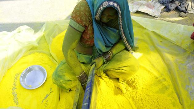 A woman preparing gulal for the festive celebrations is surrounded by heap of the powdered colour at Sector 20, in Noida. In Uttar Pradesh, tight security measures have been put in place to ensure smooth conduct during the celebrations. (Sunil Ghosh / HT Photo) A woman preparing gulal for the festive celebrations is surrounded by heap of the powdered colour at Sector 20, in Noida. In Uttar Pradesh, tight security measures have been put in place to ensure smooth conduct during the celebrations. (Sunil Ghosh / HT Photo)