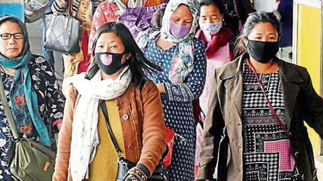 Passengers in masks at the Guwahati railway station.(ANI Photo)