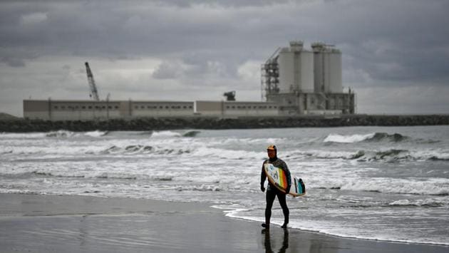 Suzuki walks on the beach in front of a thermal power station after a surfing session. He will turn 65 later this month, but hopes his passion for surfing will never again be interrupted. “When I turn 70 and a shortboard becomes too tough to manoeuvre, I am thinking about switching to a longboard.” (Charly Triballeau / AFP) Suzuki walks on the beach in front of a thermal power station after a surfing session. He will turn 65 later this month, but hopes his passion for surfing will never again be interrupted. “When I turn 70 and a shortboard becomes too tough to manoeuvre, I am thinking about switching to a longboard.” (Charly Triballeau / AFP)