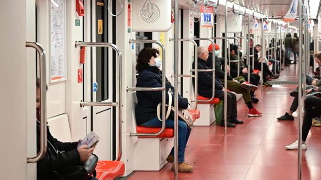 Commuters, some wearing a protective mask, travel in the underground metro in downtown Milan. Commuters could easily find seats in the usually jam-packed underground system during the morning rush hours. (Miguel Medina / AFP) Commuters, some wearing a protective mask, travel in the underground metro in downtown Milan. Commuters could easily find seats in the usually jam-packed underground system during the morning rush hours. (Miguel Medina / AFP)