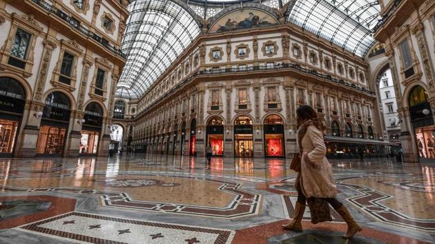 A woman walks past the deserted Vittorio Emanuele II galleria shopping mall in Milan. For at least the next three weeks, people have been told to move around only for reasons of work, for health needs or emergencies or else stay at home. Anyone travelling will have to fill in a document declaring their reasons and carry it with them. (Miguel Medina / AFP) A woman walks past the deserted Vittorio Emanuele II galleria shopping mall in Milan. For at least the next three weeks, people have been told to move around only for reasons of work, for health needs or emergencies or else stay at home. Anyone travelling will have to fill in a document declaring their reasons and carry it with them. (Miguel Medina / AFP)