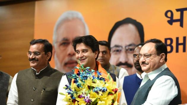 BJP chief JP Nadda welcoming Jyotiraditya Scindia into the party, at BJP headquarters in New Delhi on Wednesday.(Arvind yadav/HT Photo)