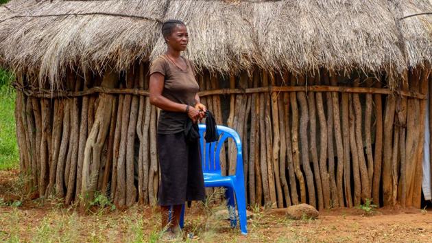 Ceu Jacinta seen next to her house in a village. Speaking in local Nhanheca, Jacinta said that she, too, was seeking paid work to resume her children’s education. But everyday struggles keep getting in the way. After Jacinta’s crops were damaged by the rains, their thatched wooden hut collapsed due to dampness and lack of maintenance. “If my husband had been around,” said Jacinta. “I don’t believe my house would have fallen this way. (Osvaldo Silva / AFP) 