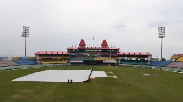 Ground staff cover the pitch ahead of tomorrow's first one day international (ODI) cricket match of a three match series between India and South Africa, at the Himachal Pradesh Cricket Association Stadium in Dharamsala on March 11, 2020. (AFP) Ground staff cover the pitch ahead of tomorrow's first one day international (ODI) cricket match of a three match series between India and South Africa, at the Himachal Pradesh Cricket Association Stadium in Dharamsala on March 11, 2020. (AFP)