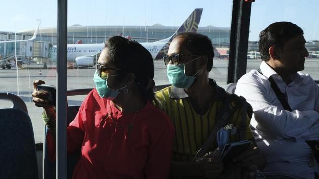 Passengers wearing masks as a precaution against coronavirus ride a bus at Chhatrapati Shivaji International Airport in Mumbai, on March 10.(AP Photo)