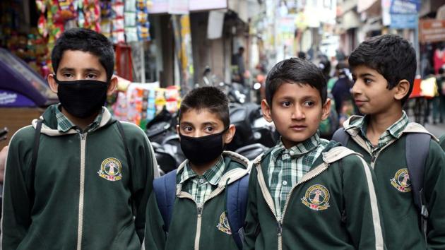 School children wear protective masks as they return from school in Jammu on March 7, 2020. (Nitin Kanotra / Hindustan Times) School children wear protective masks as they return from school in Jammu on March 7, 2020. (Nitin Kanotra / Hindustan Times)