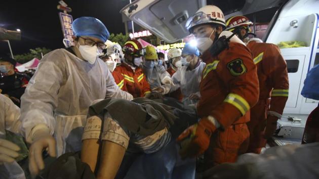 In this March 9, 2020, photo released by Xinhua News Agency, rescuers carry a woman pulled from the rubbles of a collapsed hotel to an ambulance in Quanzhou, southeast China's Fujian Province. A man was rescued from the rubble of the hotel after being burired for69 hours (AP) In this March 9, 2020, photo released by Xinhua News Agency, rescuers carry a woman pulled from the rubbles of a collapsed hotel to an ambulance in Quanzhou, southeast China's Fujian Province. A man was rescued from the rubble of the hotel after being burired for69 hours (AP)