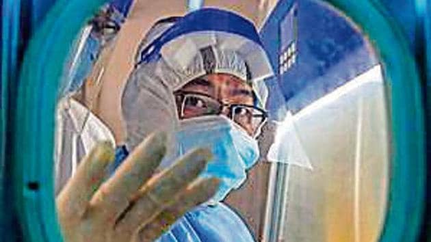 A health worker at Red Cross Hospital in Wuhan in China's central Hubei province. A health worker at Red Cross Hospital in Wuhan in China's central Hubei province.