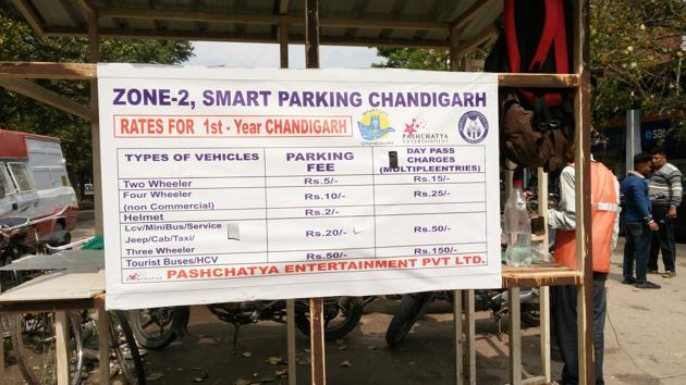 This board at a parking lot in Sector 22, Chandigarh, does not list the provision for 10-minute free parking. The facility is available for any commuter entering the lot to pick or drop passengers.(Ht Photo)