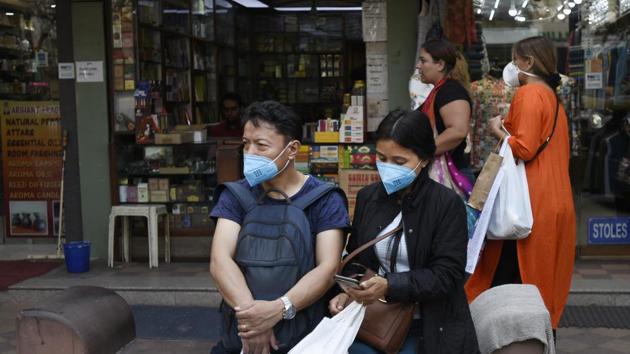 People wearing protective masks as a precautionary measure following multiple positive cases of coronavirus in the country, at Janpath Market in New Delhi on Wednesday.(Burhaan Kinu/HT Photo)