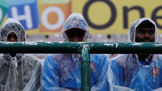 General view of fans wearing rain macs inside the stadium.(REUTERS)