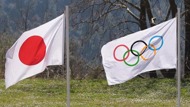The flag of Japan and the Olympic flag.(REUTERS)