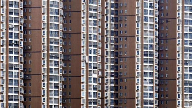 High-rise residential buildings are pictured in Wuhan. But even as the number of new reported cases falls in Wuhan, people in the city remain suspended in an isolated new normal. Residents are forbidden from venturing out of their homes even to buy food, which must be delivered. Schools and most shops remain shut, and roads are virtually empty. (REUTERS) High-rise residential buildings are pictured in Wuhan. But even as the number of new reported cases falls in Wuhan, people in the city remain suspended in an isolated new normal. Residents are forbidden from venturing out of their homes even to buy food, which must be delivered. Schools and most shops remain shut, and roads are virtually empty. (REUTERS)