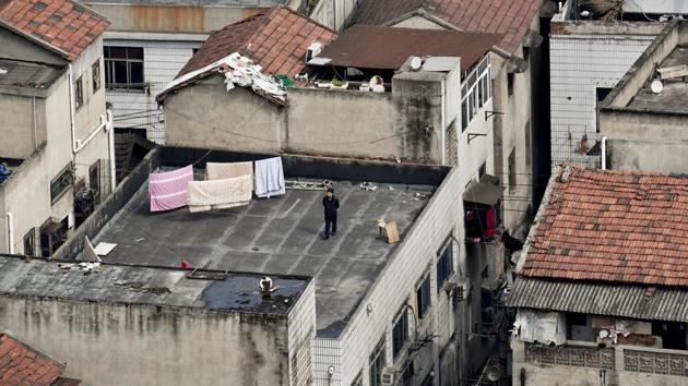 A man walks on the rooftop of a building at a residential compound. The outbreak has also exacted an unquantifiable psychological toll on people in Wuhan as families cope with loss, children are unable to go to school or play outside, and livelihoods are imperilled as people can’t go to work. (REUTERS) A man walks on the rooftop of a building at a residential compound. The outbreak has also exacted an unquantifiable psychological toll on people in Wuhan as families cope with loss, children are unable to go to school or play outside, and livelihoods are imperilled as people can’t go to work. (REUTERS)