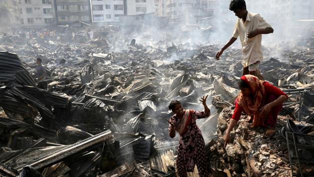 Slum dwellers search for their household items after a fire broke out in a slum in Dhaka, Bangladesh. (Mohammad Ponir Hossain / REUTERS) Slum dwellers search for their household items after a fire broke out in a slum in Dhaka, Bangladesh. (Mohammad Ponir Hossain / REUTERS)