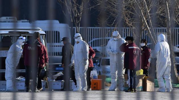 Health workers wear protective suits as a preventive measure against the COVID-19 coronavirus as they unpack safety equipment outside the New China International Exhibition Centre, near Beijing Capital Airport in Beijing on March 13, 2020. (AFP photo) Health workers wear protective suits as a preventive measure against the COVID-19 coronavirus as they unpack safety equipment outside the New China International Exhibition Centre, near Beijing Capital Airport in Beijing on March 13, 2020. (AFP photo)