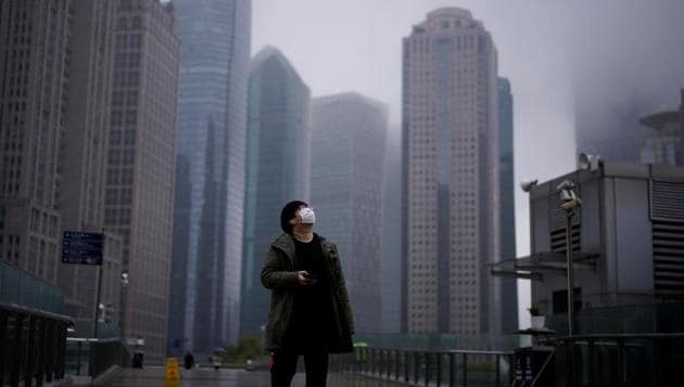 A man wearing a protective face mask is seen following an outbreak of coronavirus (COVID-19), at Lujiazui financial district in Shanghai, China. The coronavirus has killed more than 3,000 people in mainland China. It had also stalled the world’s second-largest economy as, beginning in January, authorities ordered work stoppages, travel restrictions and home quarantines. (Aly Song / REUTERS)
