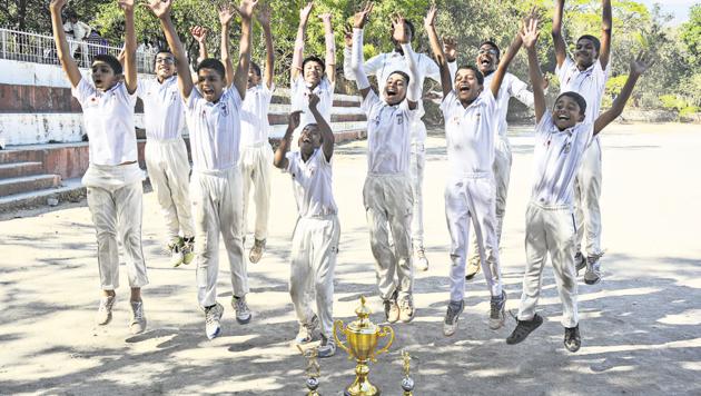The Symbiosis High School ‘B’ under-14 team celebrate after winning the PDCA cricket tournament on Thursday at the Law College ground. Symbiosis defeated Jai Hind High School in the final.(SHANKAR NARAYAN/HT)