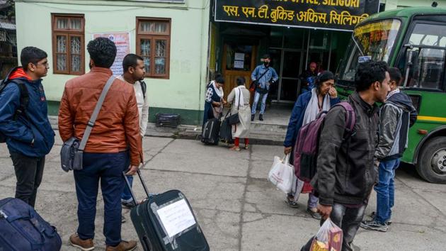 Travellers stand in front of the Sikkim Nationalised Transport office in Siliguri as they wait for transport following a ban put by the Sikkim government on all foreign tourists due to coronavirus outbreak, March 6, 2020. (AFP) Travellers stand in front of the Sikkim Nationalised Transport office in Siliguri as they wait for transport following a ban put by the Sikkim government on all foreign tourists due to coronavirus outbreak, March 6, 2020. (AFP)
