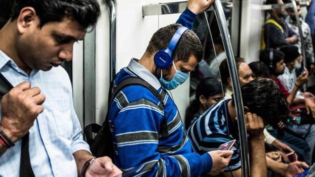 A commuter (C) wearing a facemask as a preventive measure against the spread of coronavirus. PM Modi asked his SAARC counterparts to devise a strategy to take on the coronavirus pandemic which has affected over 100 countries across the globe. (XAVIER GALIANA / AFP) A commuter (C) wearing a facemask as a preventive measure against the spread of coronavirus. PM Modi asked his SAARC counterparts to devise a strategy to take on the coronavirus pandemic which has affected over 100 countries across the globe. (XAVIER GALIANA / AFP)